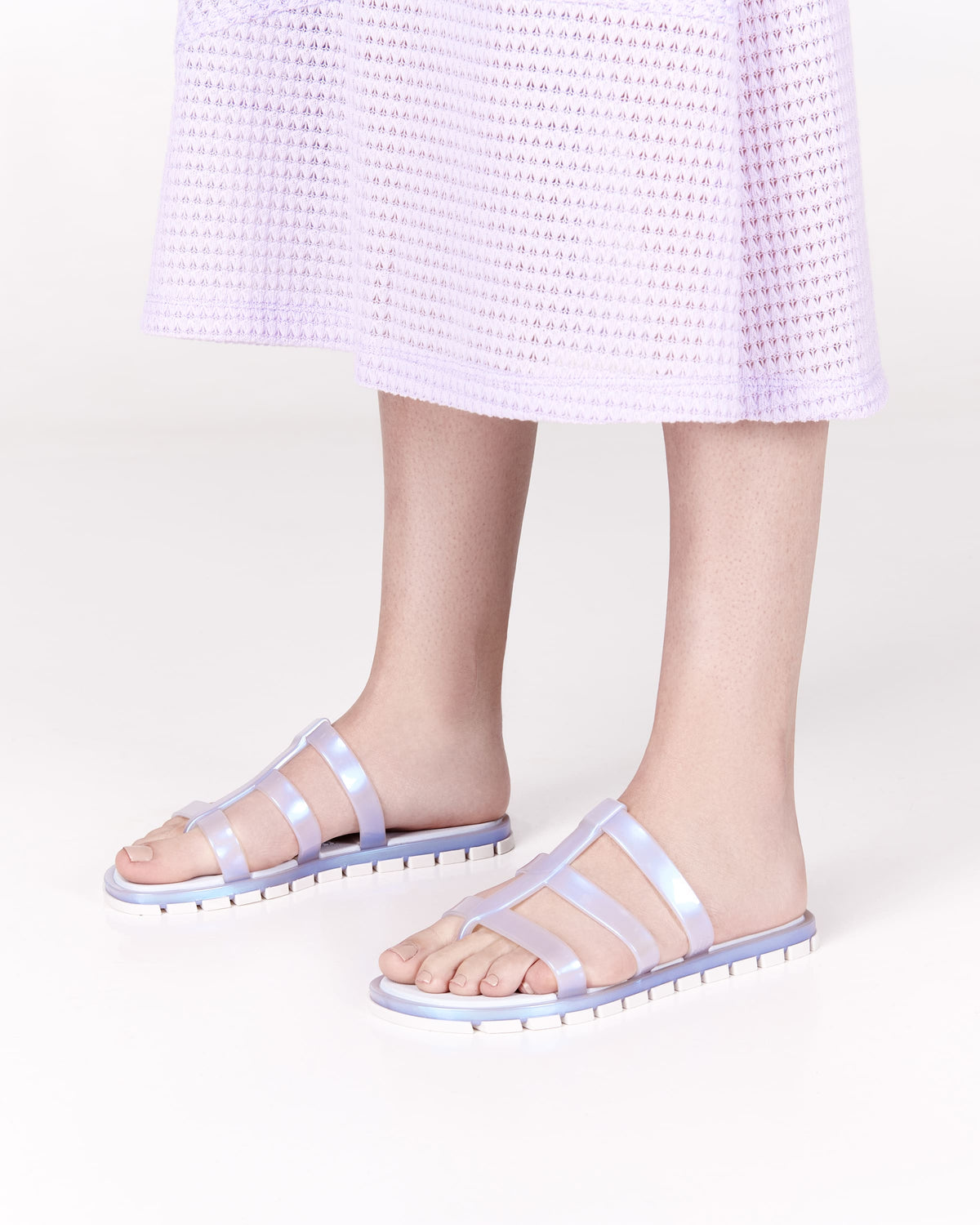 Model's legs wearing a pair of pearly blue Path adult sandals with blue sole