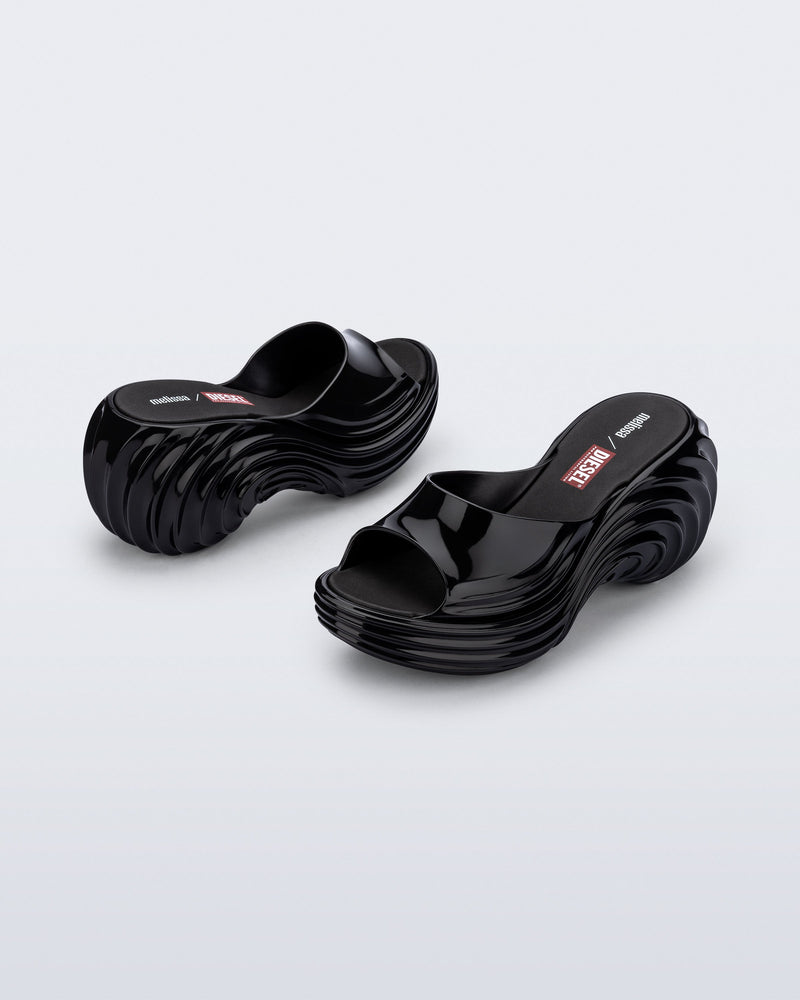 Back and side view of a pair of black Platforms + Diesel slides