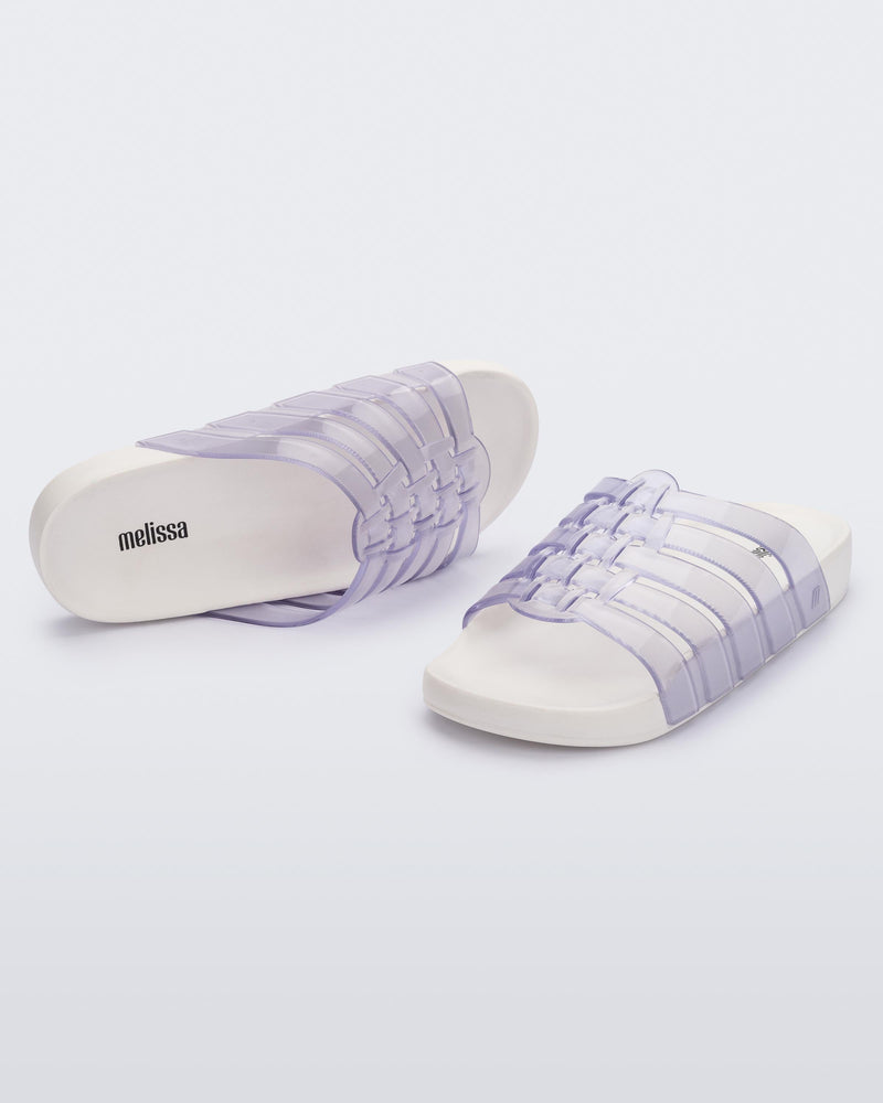 Top and angled view of a pair of clear Possession Slide with white sole