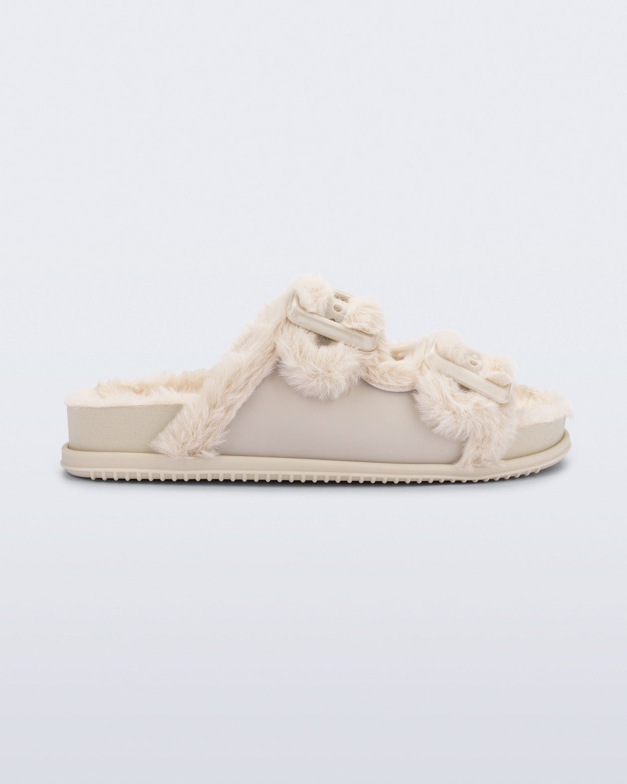 Side view of an beige Cozy Warm Slide with beige fuzzy insole