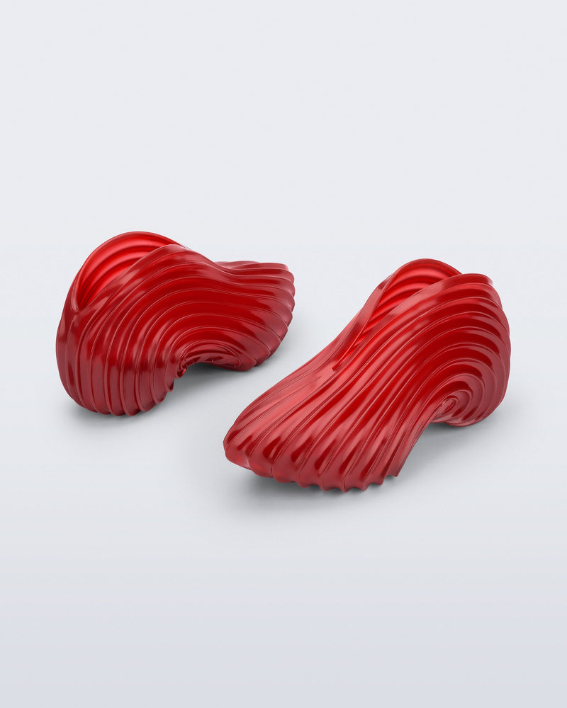 Back and angled view of a transparent red Sneaker + Diesel