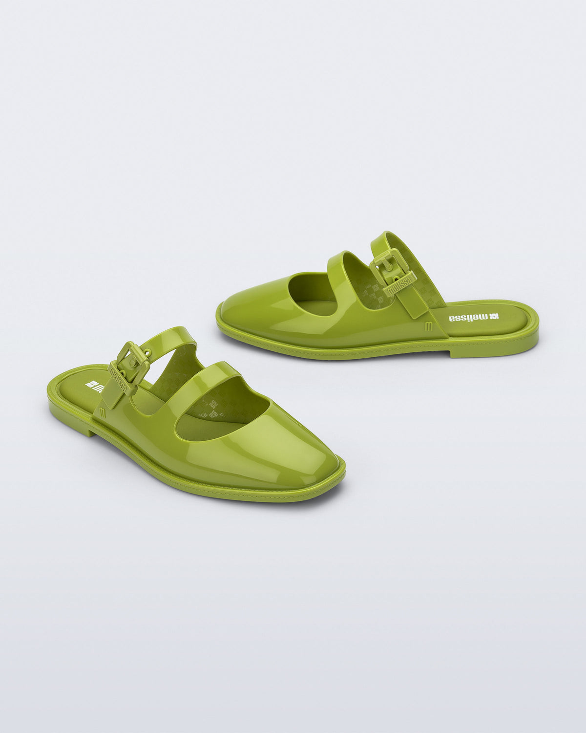 Side and angled view of a pair of green Anastasia mule slides