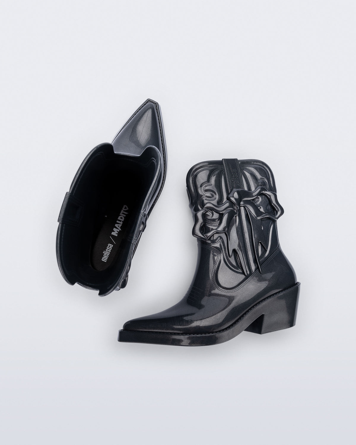 Top and side view of a pair of metallic grey Texas + Maldito boots