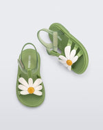Top and side view of a pair of green baby Hip Bloomy sandal with a white flower