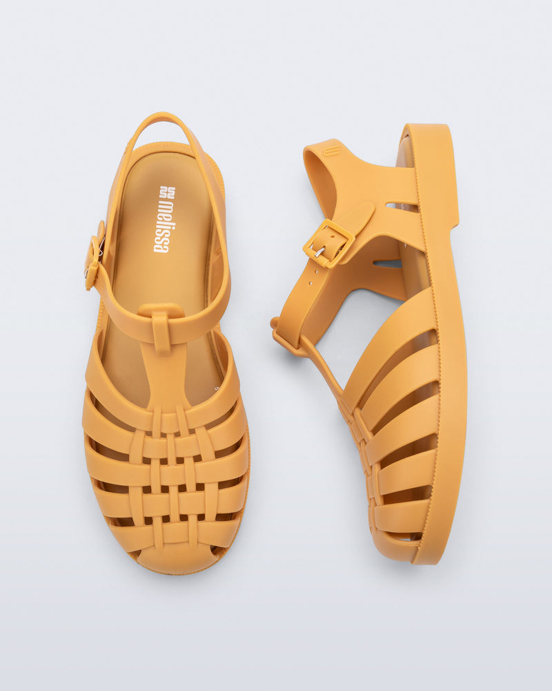 Top and side angled view of a pair of matte caramel Possession kids fisherman sandals.