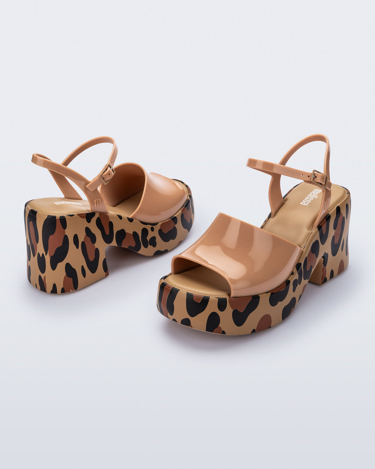 Angled view of a pair of brown with animal print sole Lina platform heels