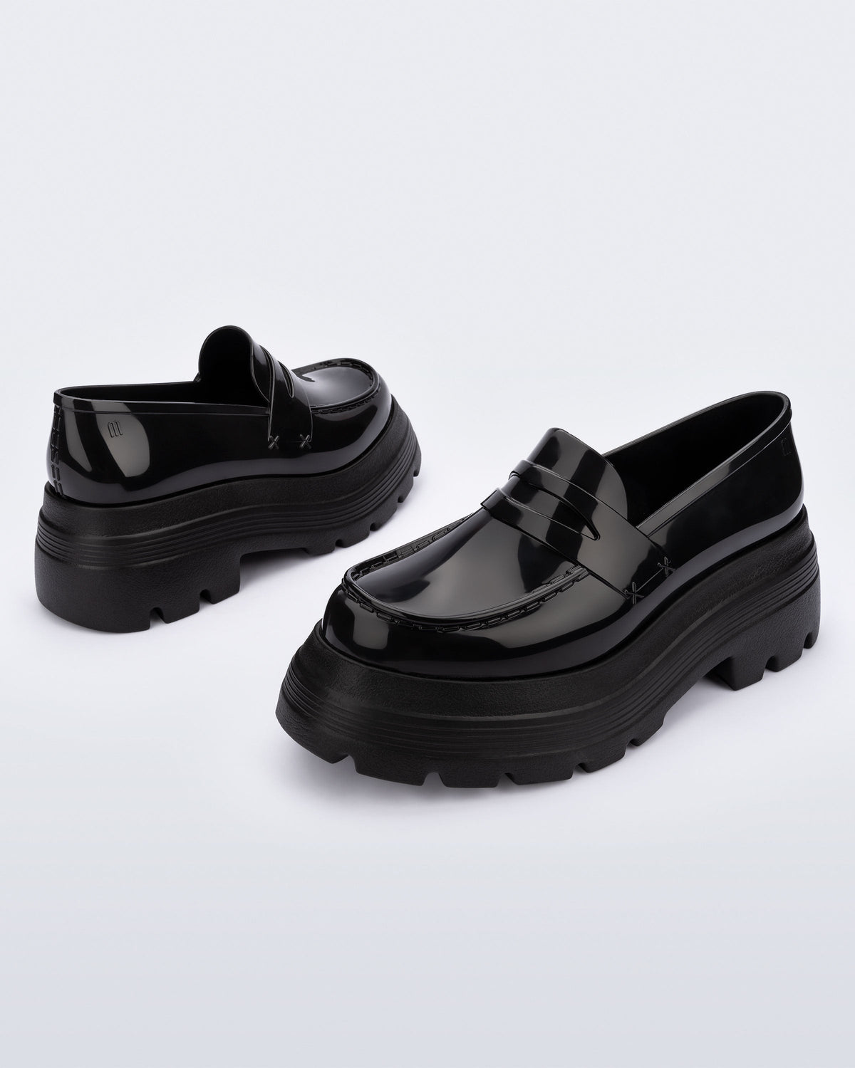 Angled view of a pair of black Royal High + Undercover platform loafers.