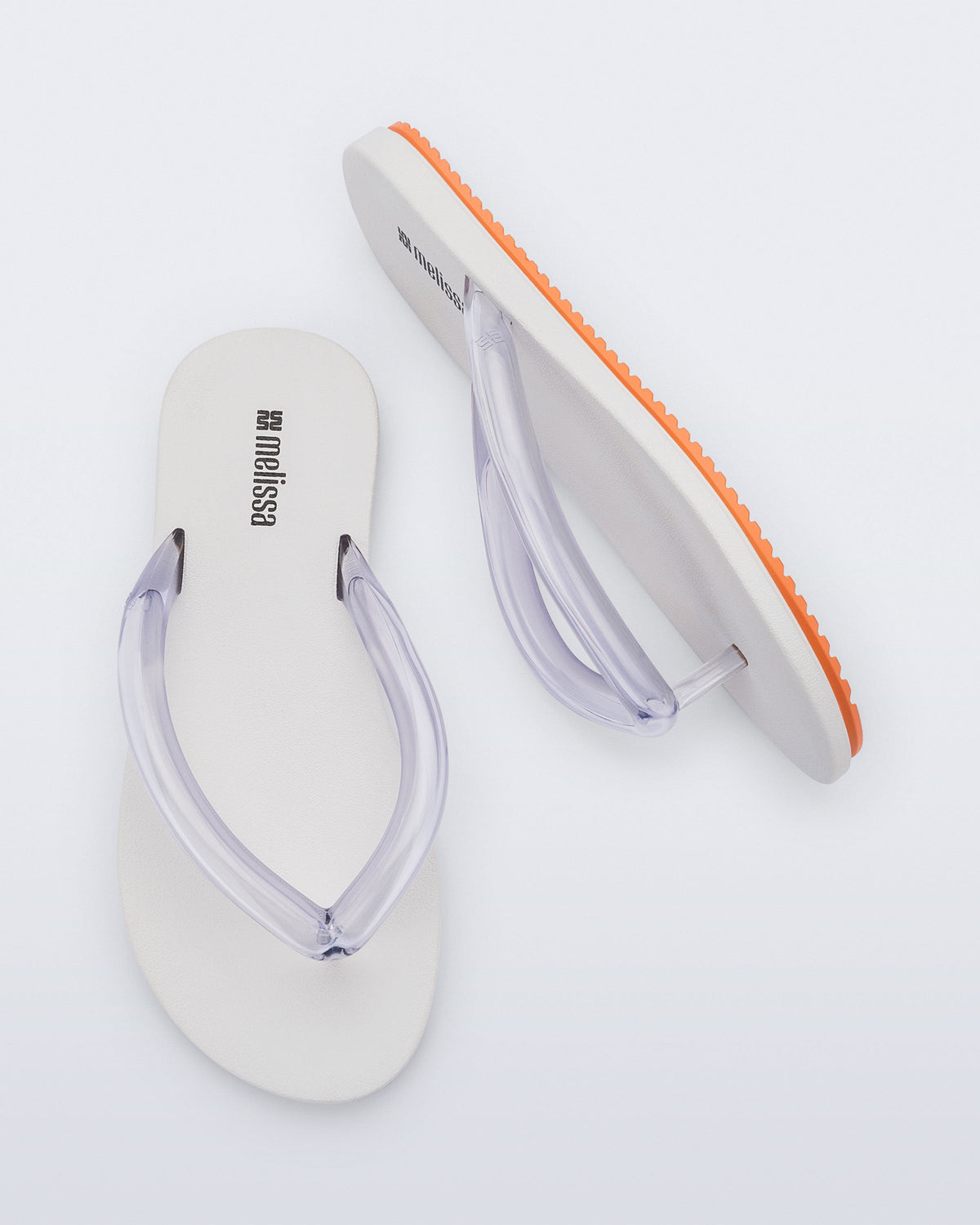Top and side view a pair of white Flip Flop Airflow sandal with a clear strap and orange bottom