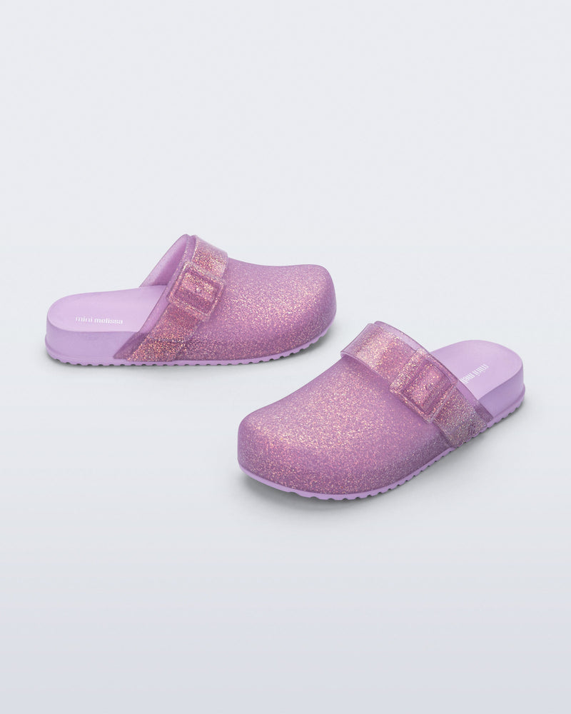Side and angled view of a pair of glitter lilac Cozy Clog for kids