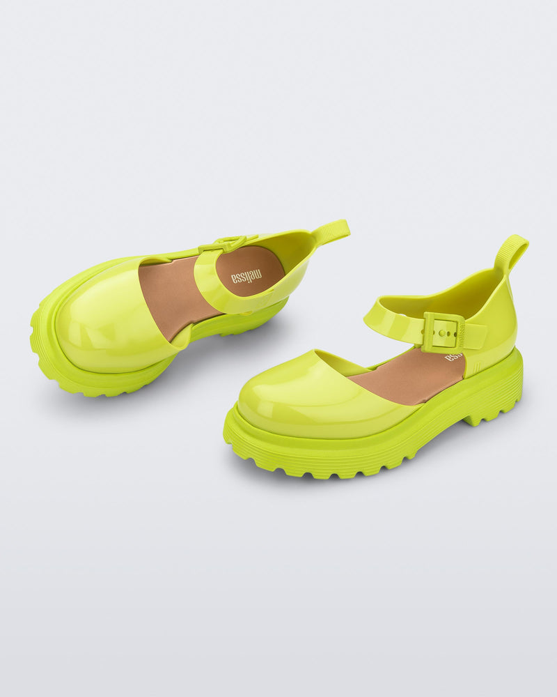 Side and angled view of a pair green Ellie ankle strap loafers