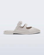Side view of a beige Anastasia mule slide with upper straps