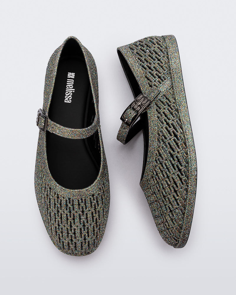 Top and side view of a pair of dark silver glitter Harper flat with strap