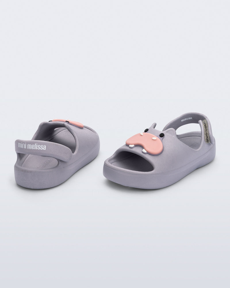 Back and angled view of a pair of grey Free Cute baby sandals with hippo face on front upper