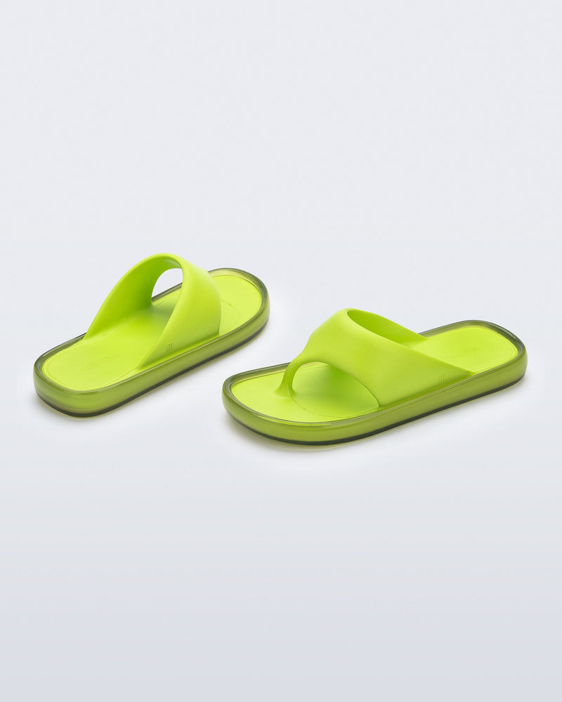 Angled view of a pair of green Float flip flops