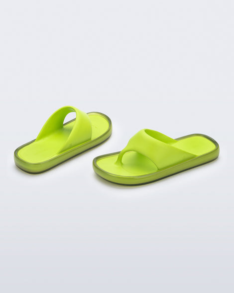 Angled view of a pair of green Float flip flops