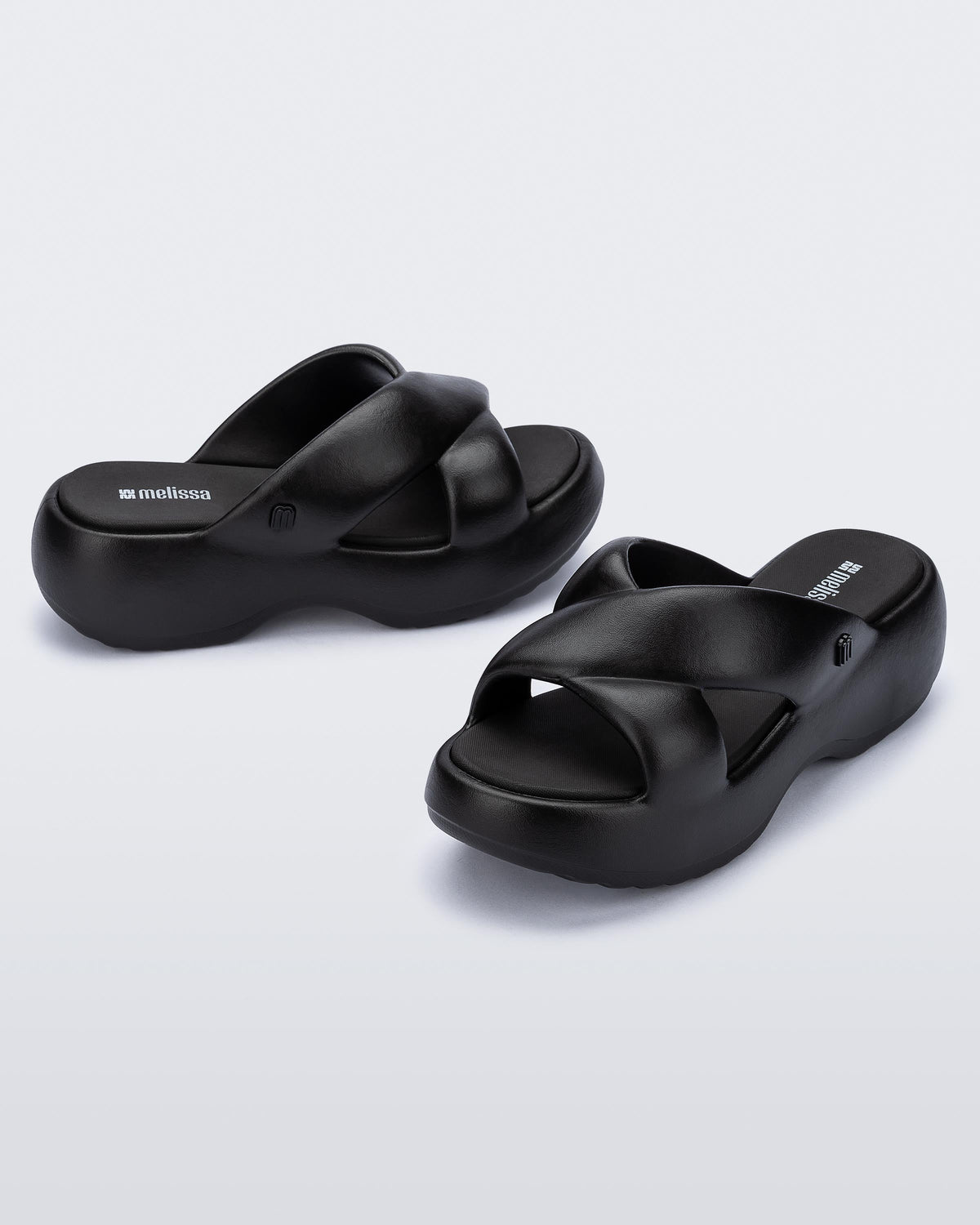 Side and angled view of a pair of black Free Rise platform slide