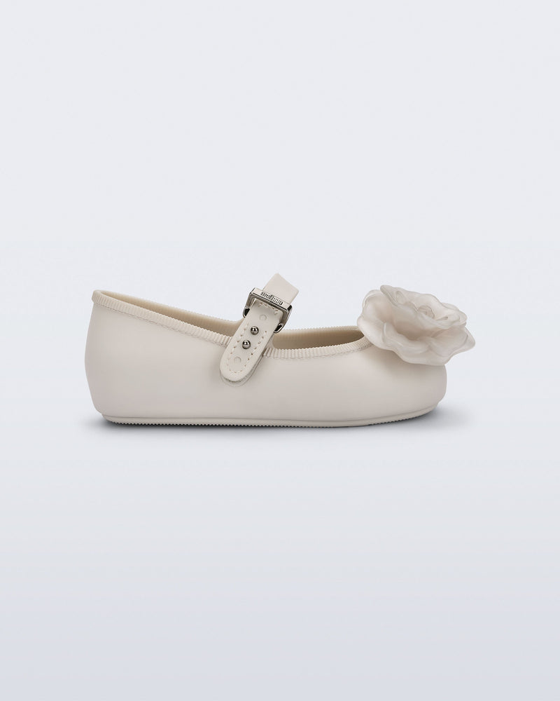 Side view of a beige Soft Ballerina baby flat with beige flowers