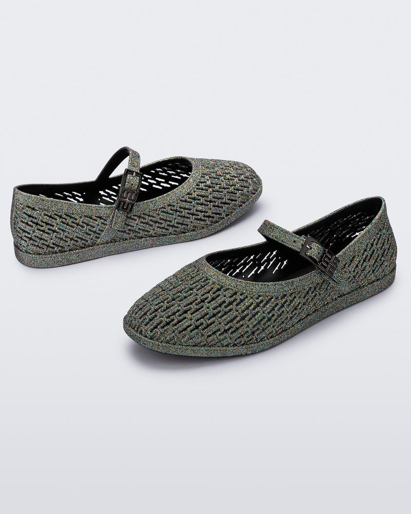 Top and angled view of a pair of dark silver glitter Harper flat with strap