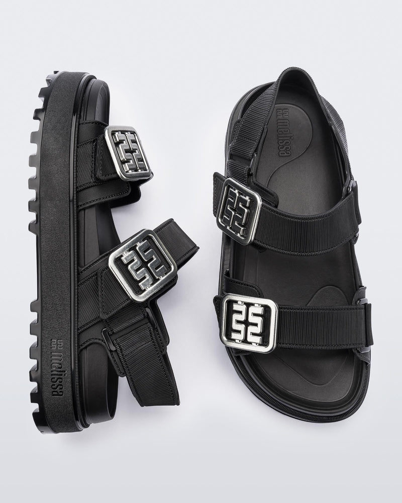 Side and top view of a pair of black Towny sandals with straps and silver buckle