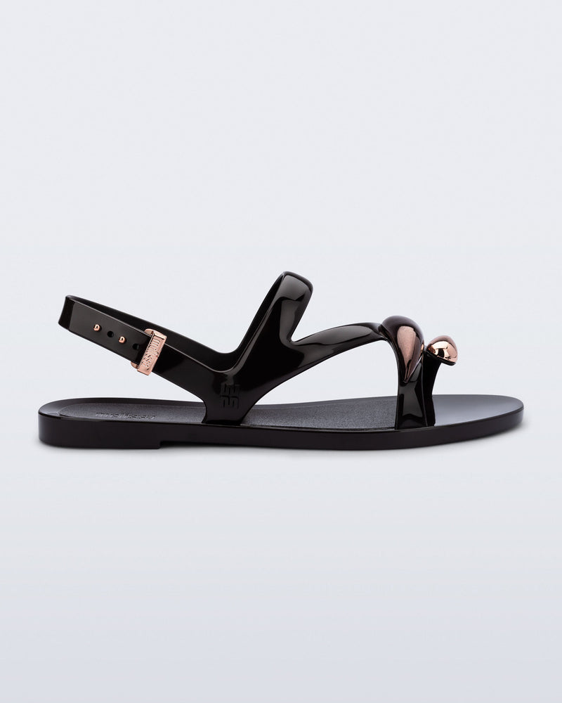 Side view of an black Iris sandal with copper upper embellishments