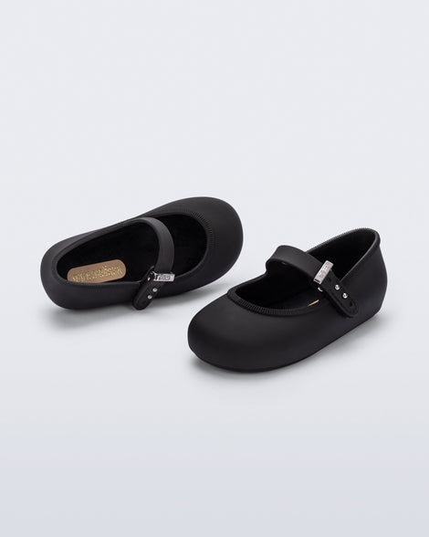 Top and side angled view of a pair of black Soft Ballerina baby flat with Velcro strap