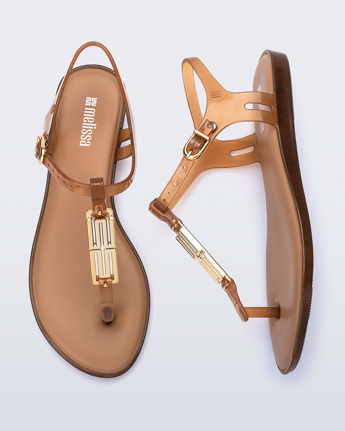 Side and top view of a pair of brown Solar M Chic sandals with gold embellishment