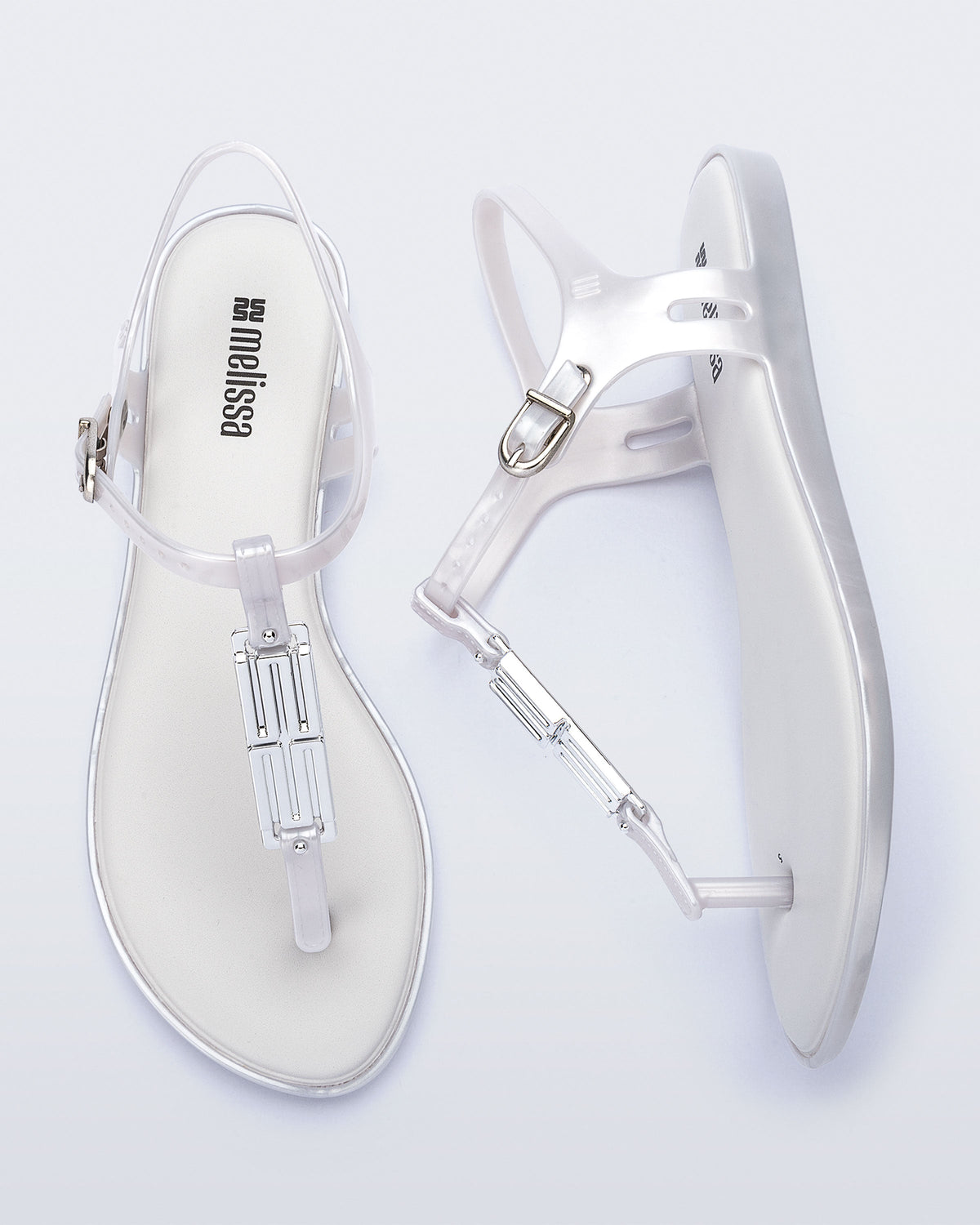 Side and top view of a pair of pearly white Solar M Chic sandals