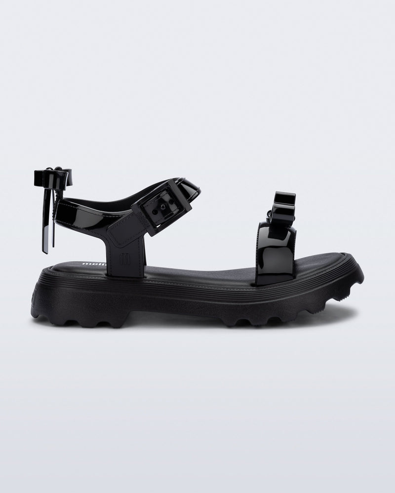 Side view of a black Town Bow sandal