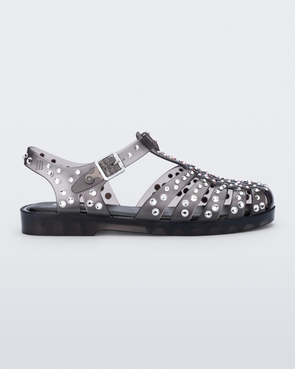 Side view of a clear black Possession Crystals sandal