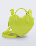 Front view of a green Heartbeat bag with small handles and longer strap.