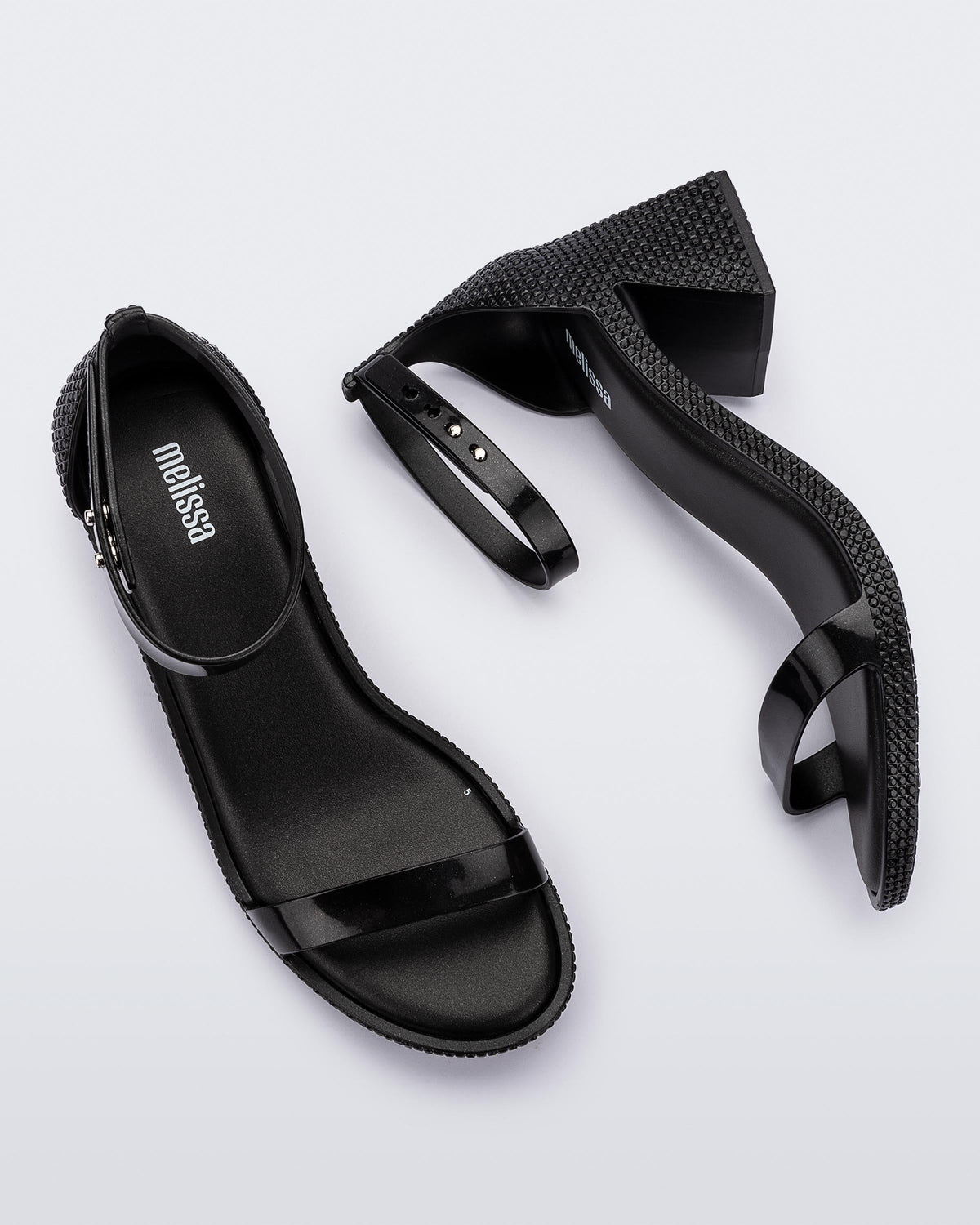 Top and side view of a pair of metallic black Lux Heels