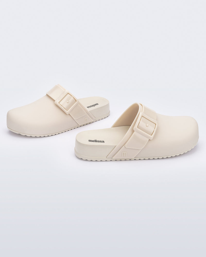 Angled view of a pair of adult beige Cozy Clog.