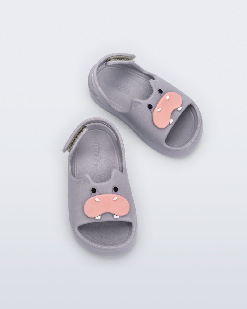 Top view of a pair of grey Free Cute baby sandals with hippo face on front upper