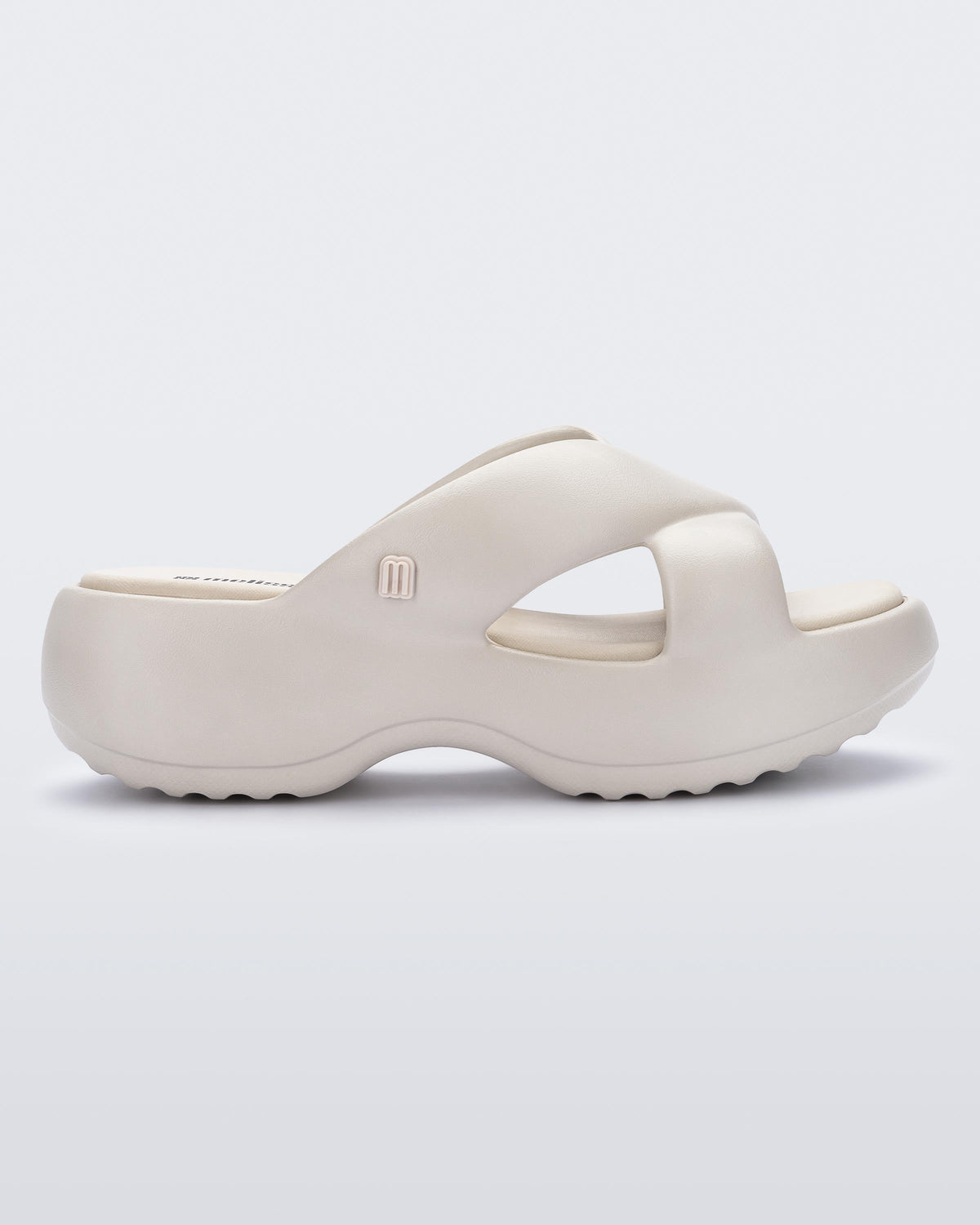 Side view of a beige Free Rise platform slide sandal