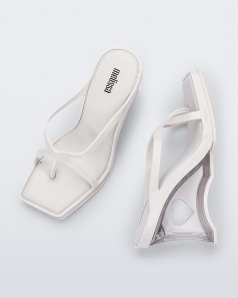 Side and top view of a pair of white Glass Heels with a heart cutout in the heel.