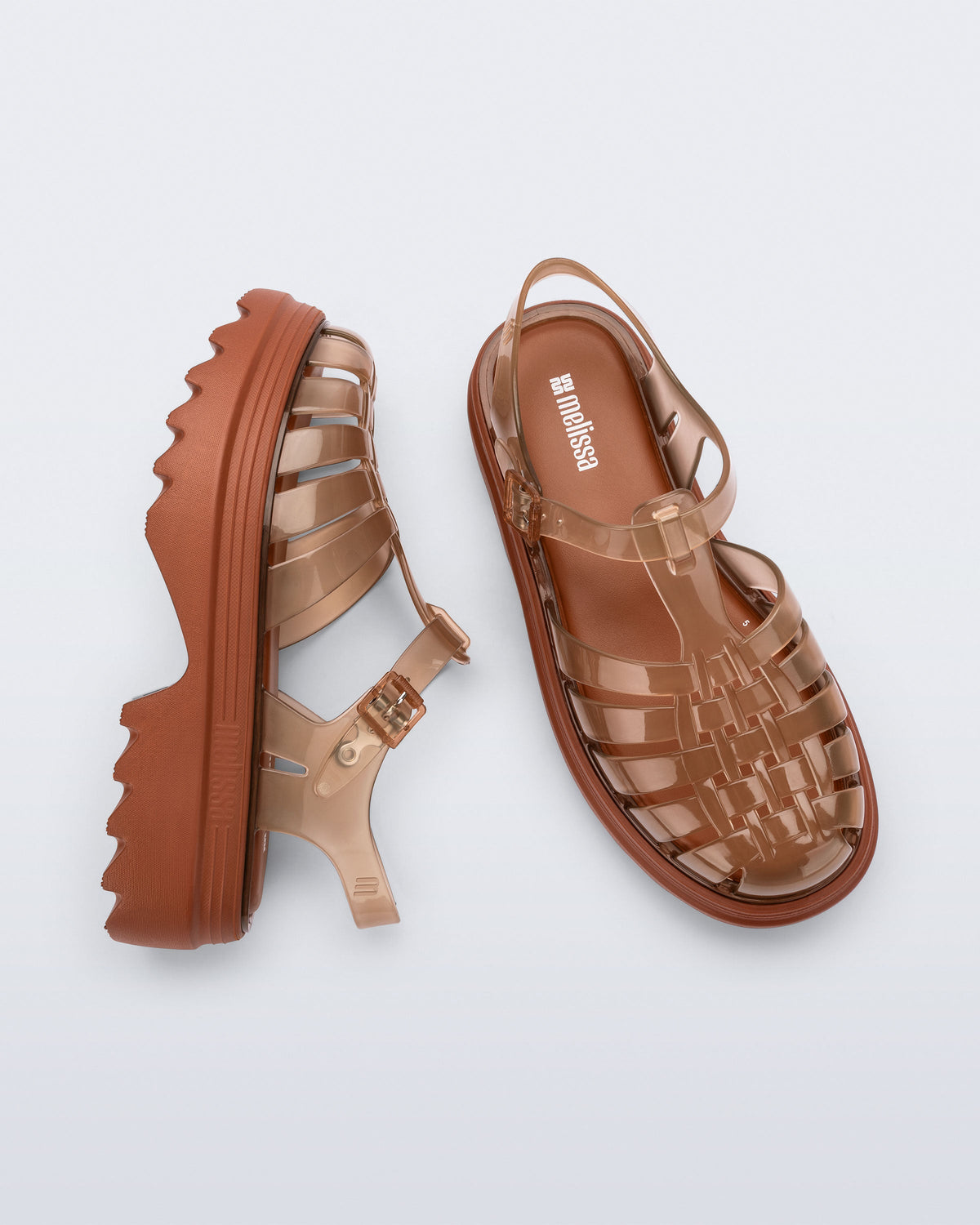 Side and top view of a pair of transparent brown Possession Platform II fisherman sandals