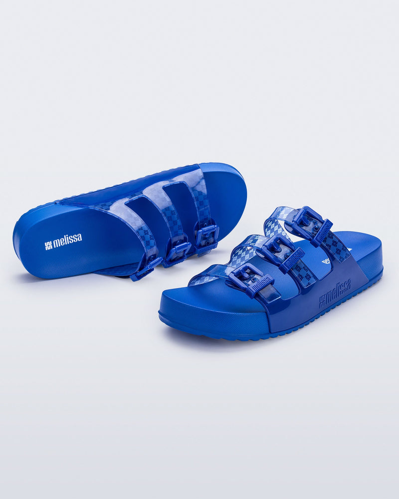 Top and angled view of a pair of blue Cozy Stripes slides