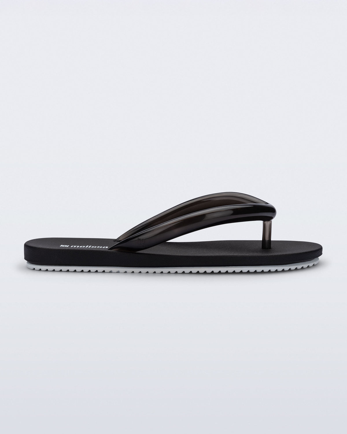 Side view of a black Flip Flop Airflow sandal with white bottom