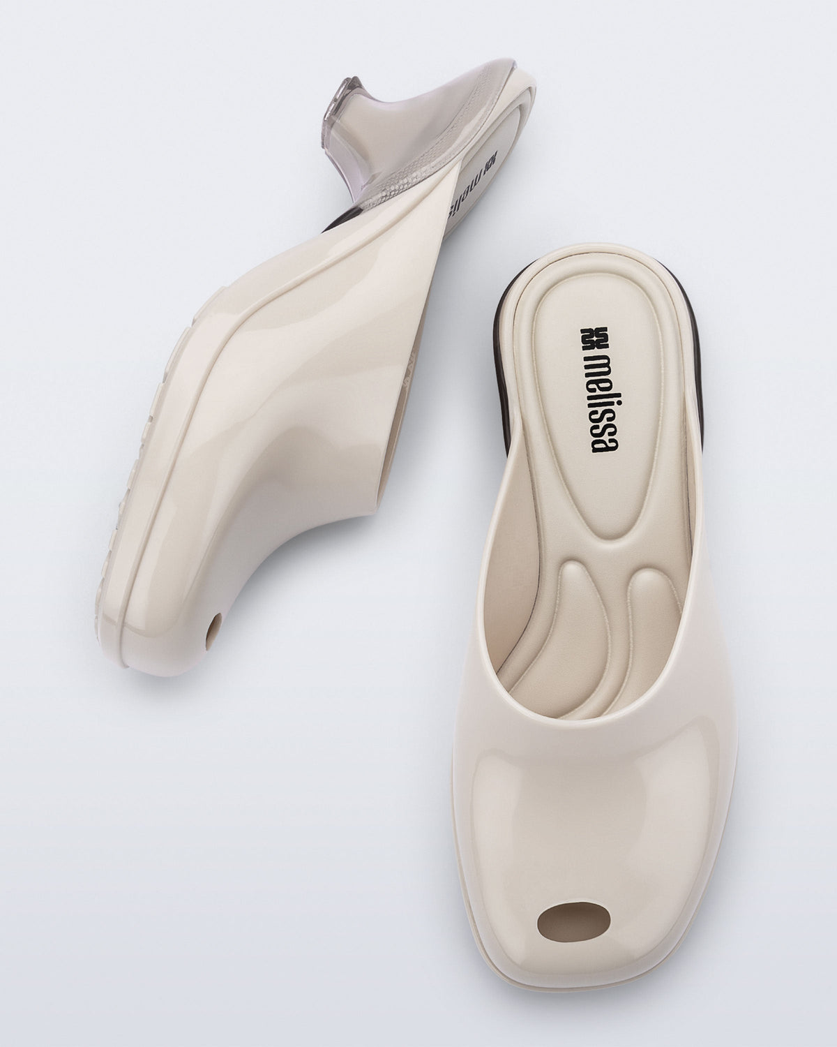 Top and side view of a pair of light beige Gaia kitten heels with peep toe