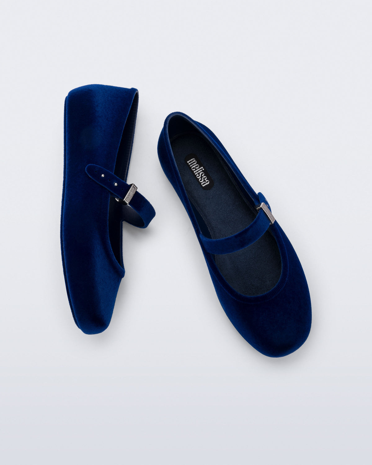 Side and top view of a pair of blue Soft Ballerina Velvet II flats