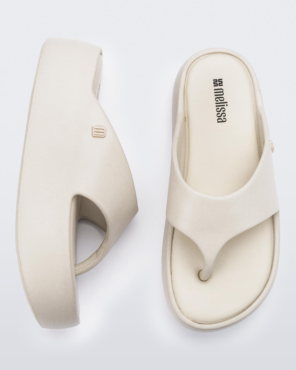 Side and angled view of a pair of beige Free Platform Thong sandal