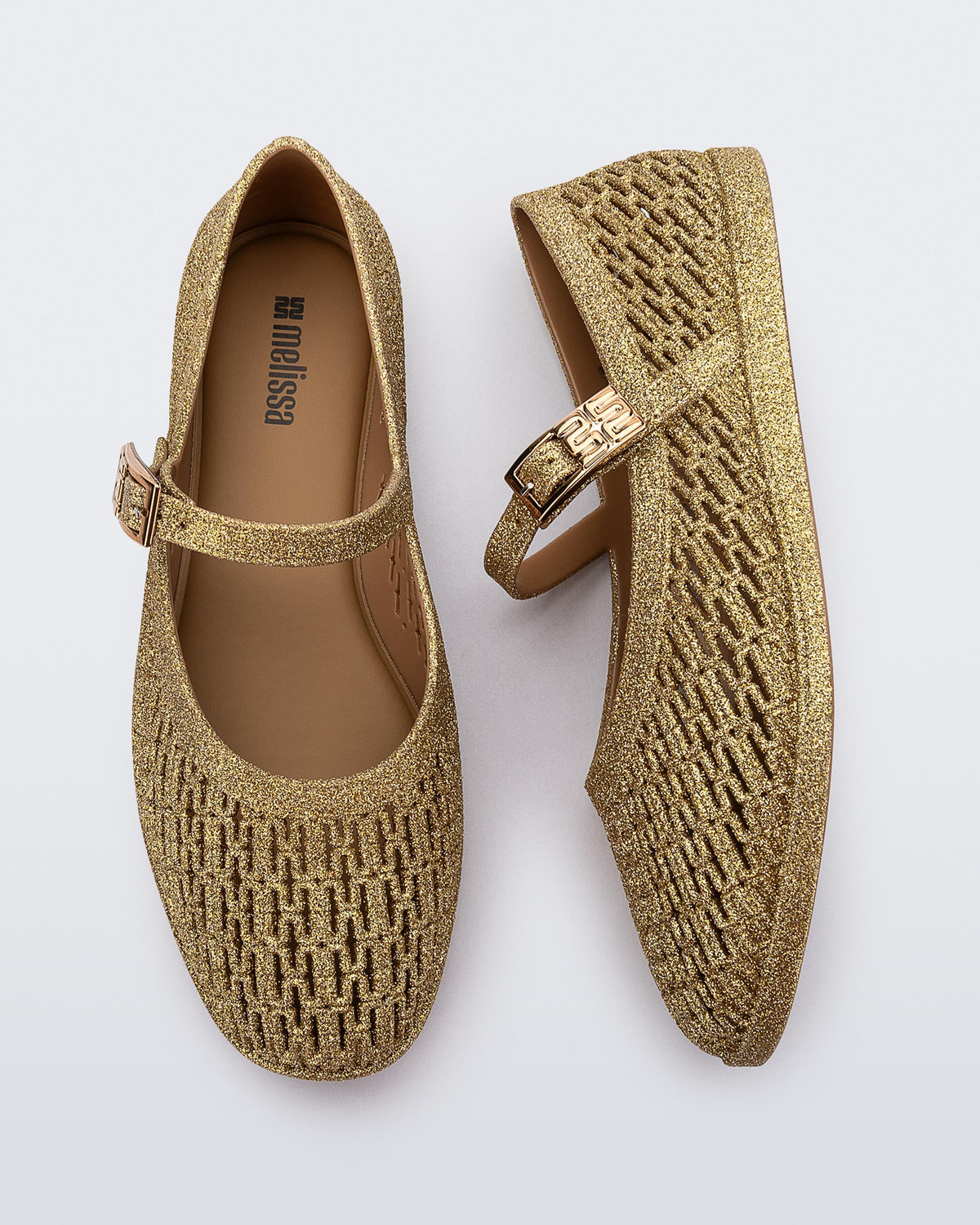 Top and side view of a pair of beige glitter Harper flat with strap