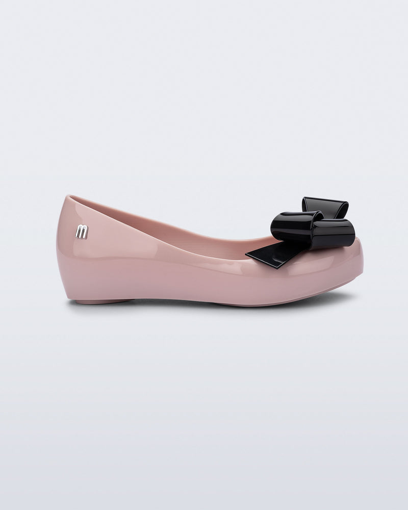 Side view of a pink Ultragirl Classy kids ballerina with black bow.