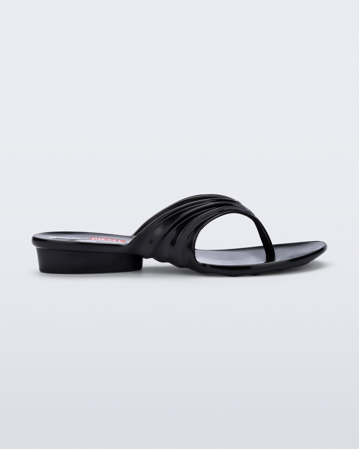 Side view of a black Flip Flop + Diesel sandals