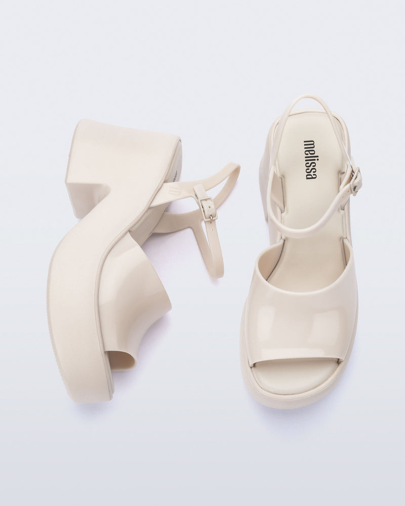Top and side view of a pair of beige Lina platform heels