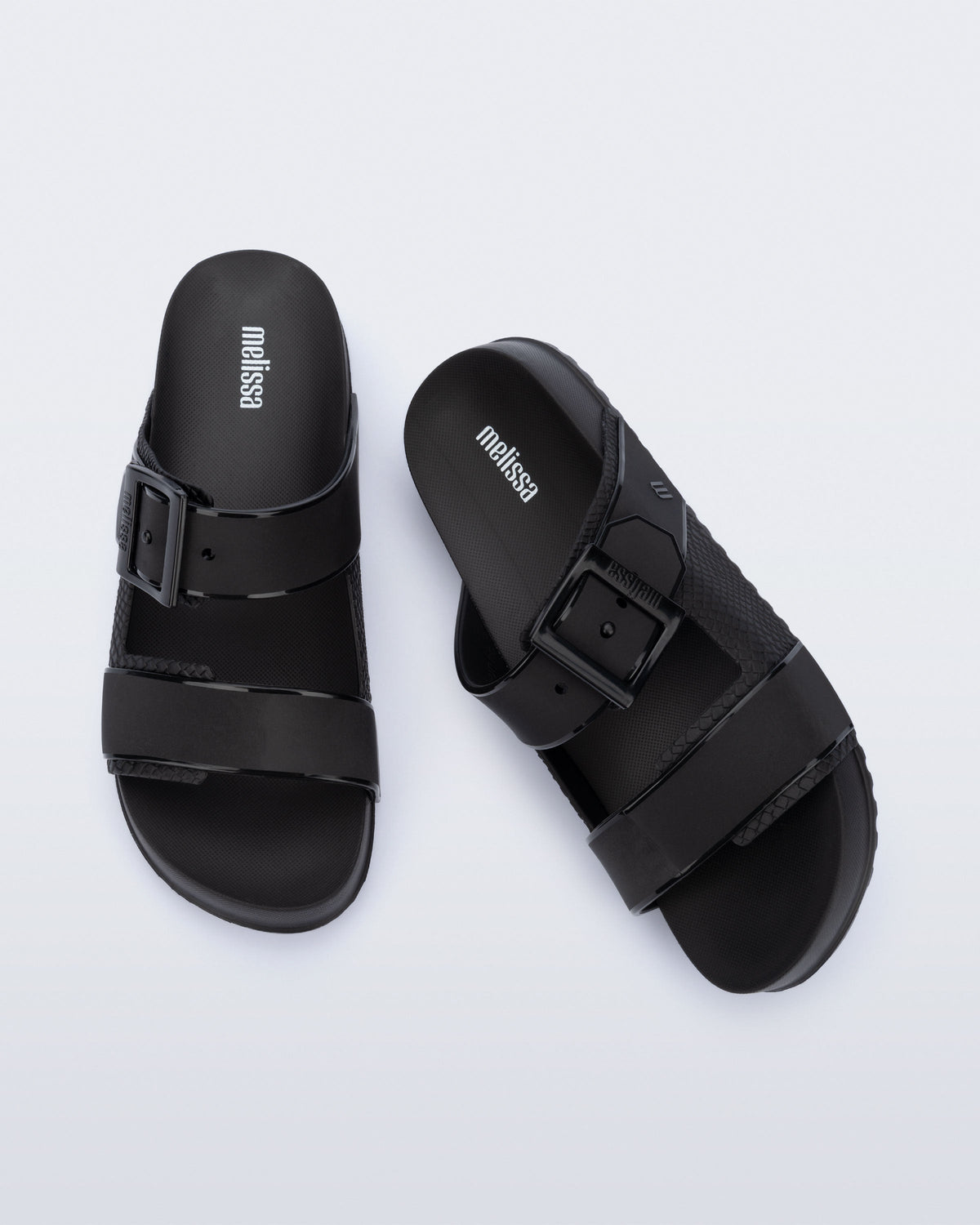 Top view of a pair of black Cozy Connection slides