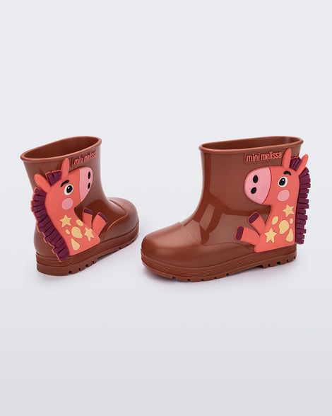 Back and side view of a pair of brown Welly Wonderland baby boots with orange pony on side