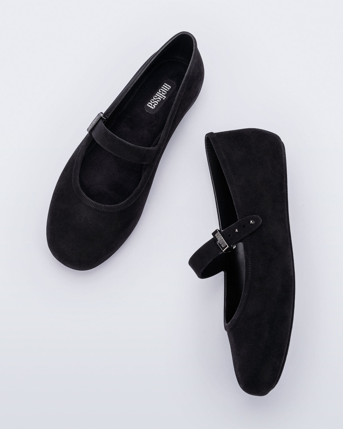 Side and top view of a pair of black Soft Ballerina Velvet flats