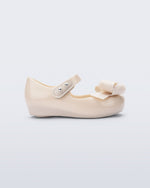 Side view of a beige Ultragirl Classy baby ballerina with beige bow.