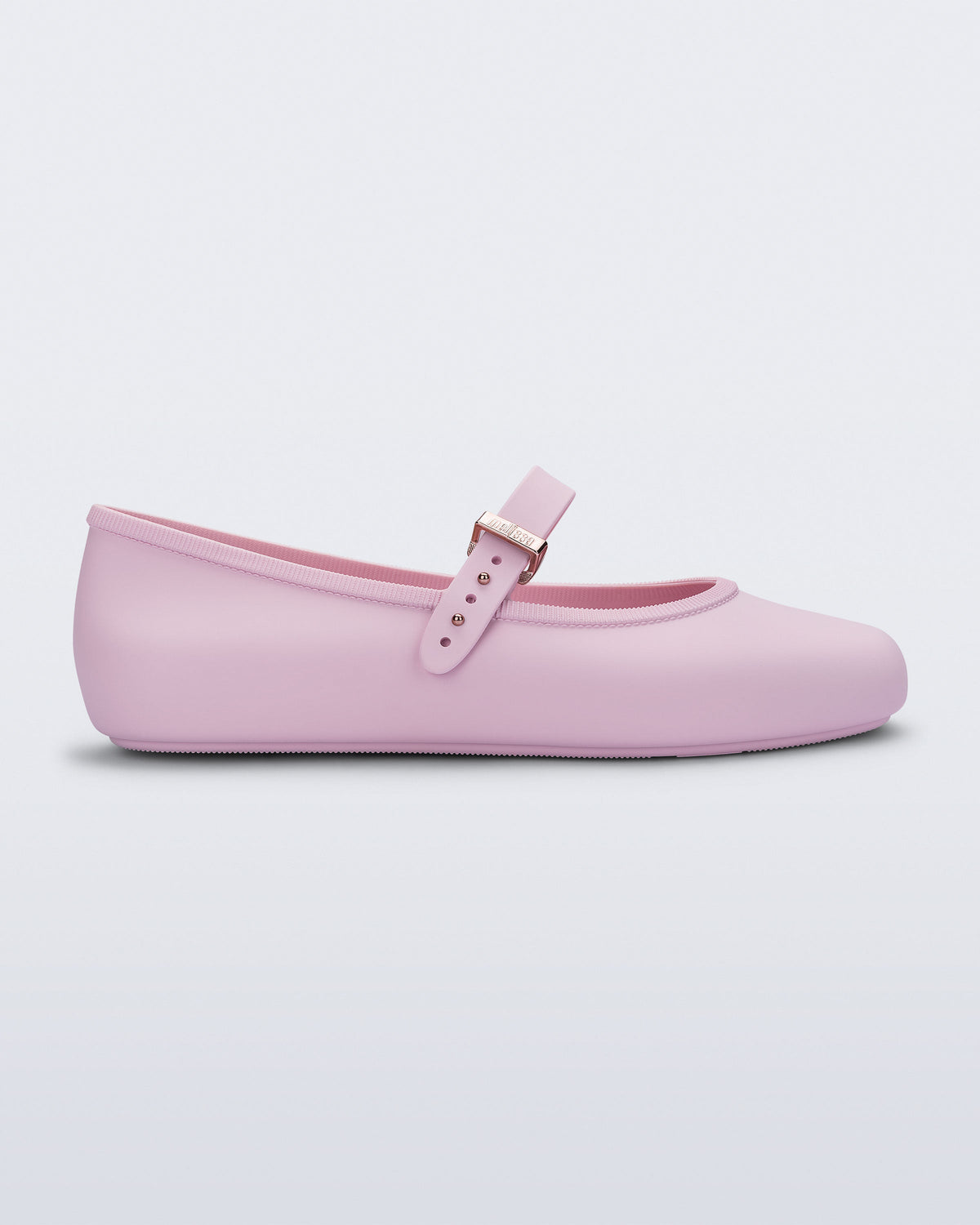 Side view of a pink Soft Ballerina flat with top buckle strap